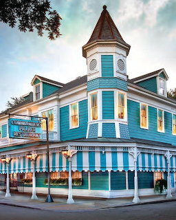 Turquoise and white Victorian building of Commander's Palace restaurant in New Orleans with a pointed tower