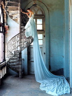 Woman in Blue Gown on Spiral Staircase