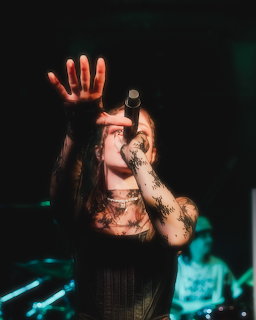 Chrissy Costanza with long dark hair posing for a portrait