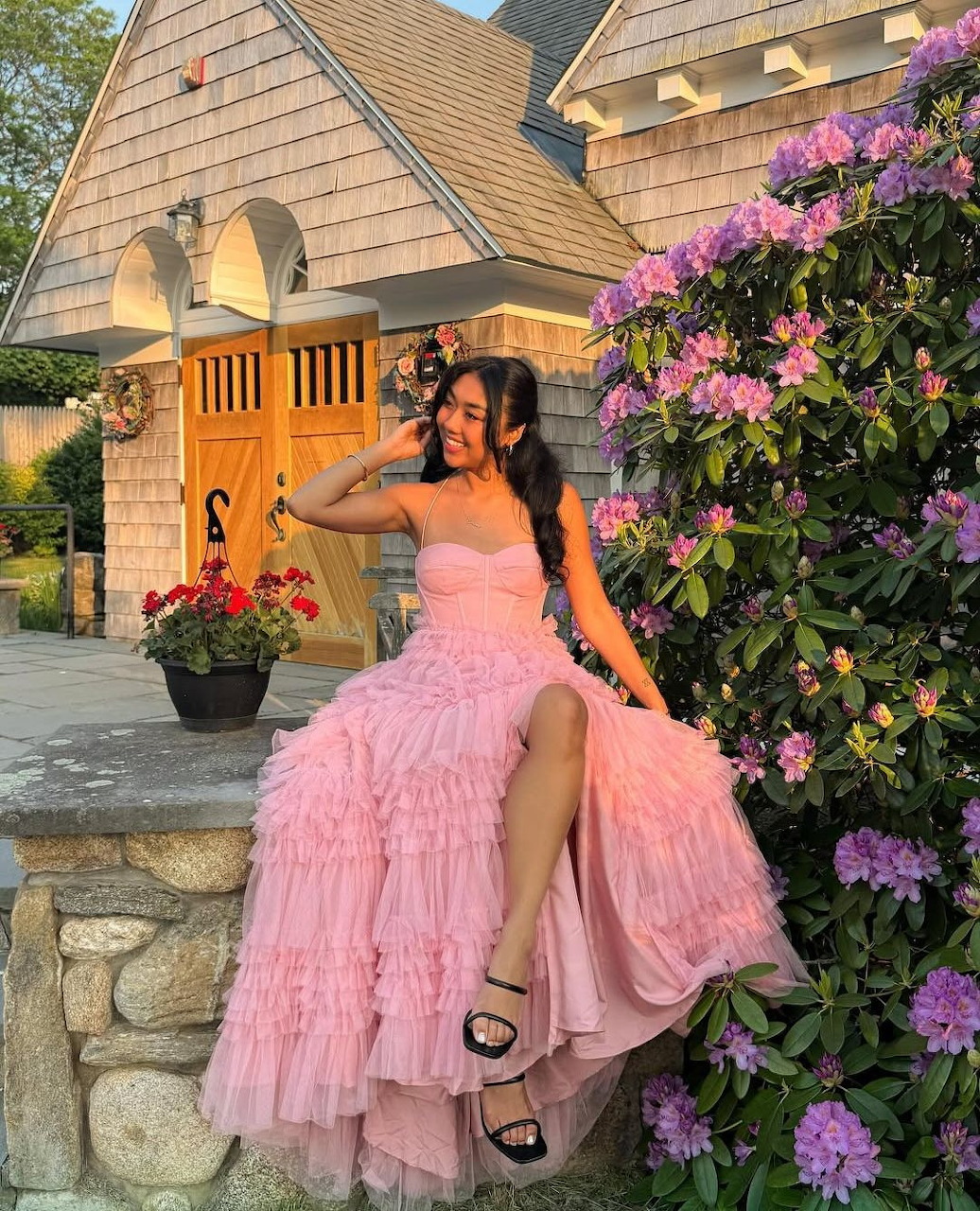 Woman in an elegant pink dress posing in soft lighting