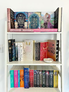 White bookshelf filled with colorful books and decorative bookends