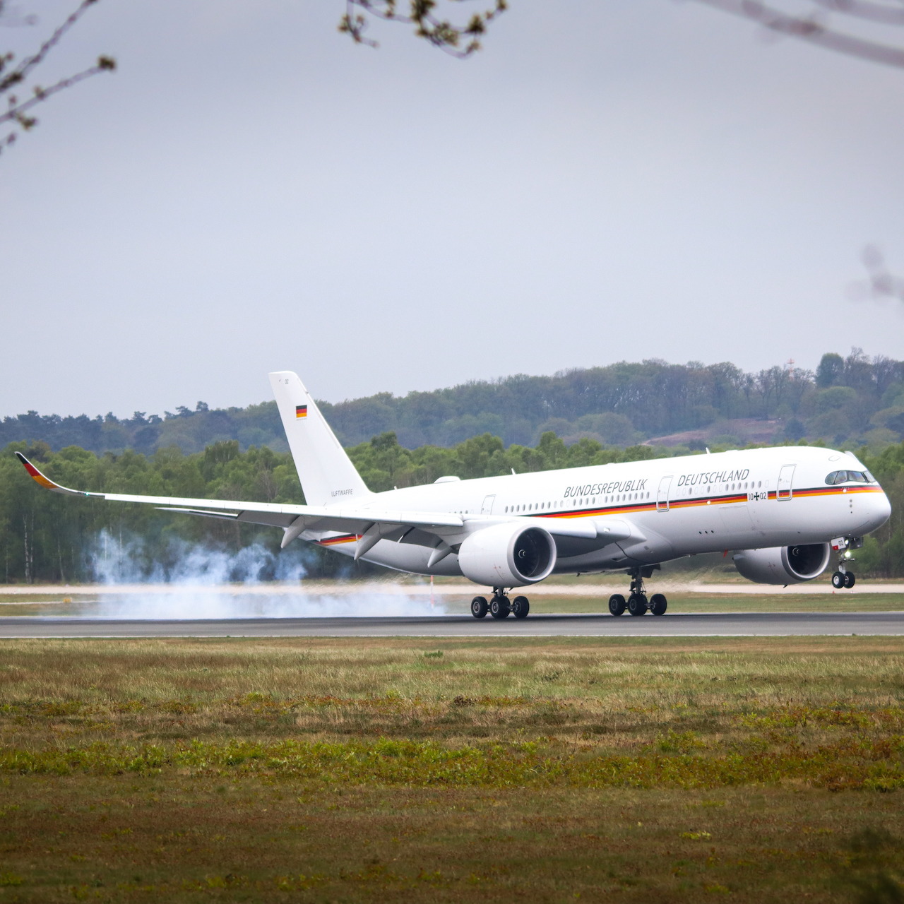 German Luftwaffe Airbus A350 landing on runway with smoke from tires