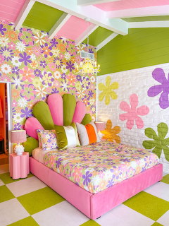 Colorful flower-themed bedroom with pink bed, floral wallpaper, and green checkered floor