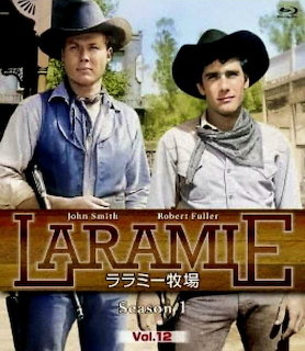 Vintage western poster showing two cowboys in hats standing outdoors with the title Laramie