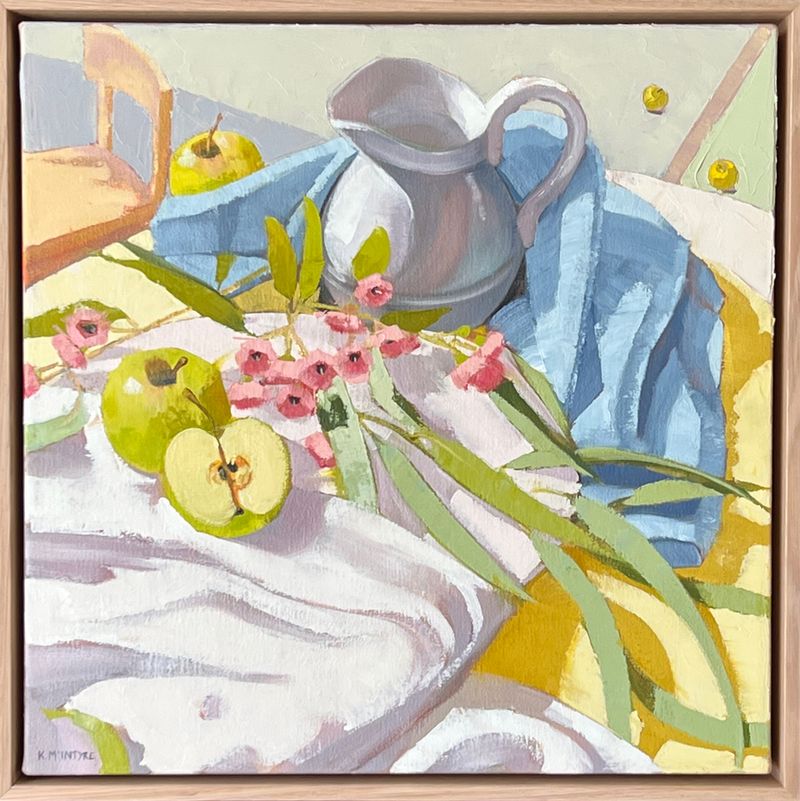 Still life painting with green apples, pink gum blossoms, a metal jug, and blue cloth on a table