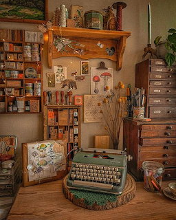 Cozy vintage desk scene with a green typewriter, wooden drawers, shelves, and small stationery items