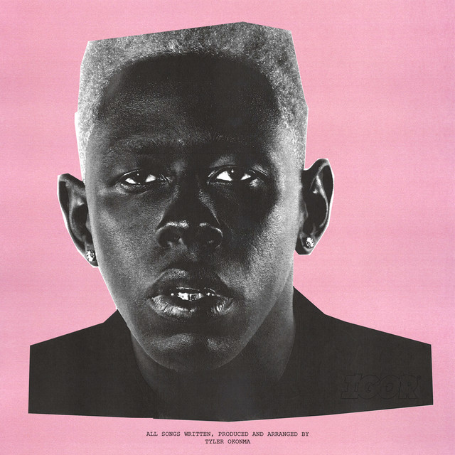 Black-and-white portrait of a man with a flat-top haircut against a pink background