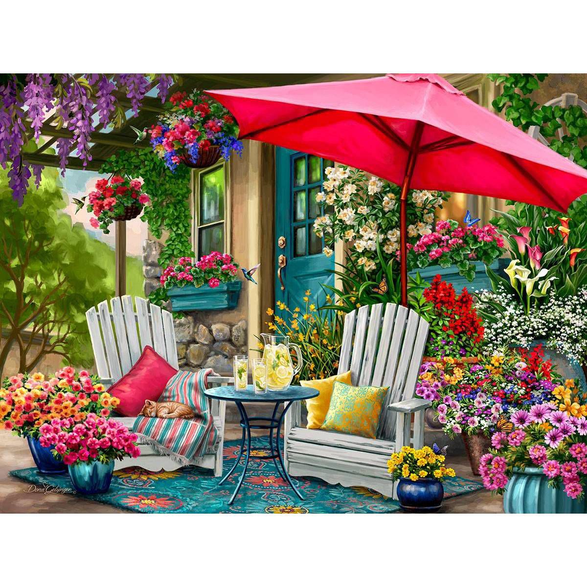 Garden patio with white chairs, red umbrella, and colorful flowers
