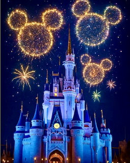Castle with blue turrets and Mickey-shaped golden fireworks in starry night sky