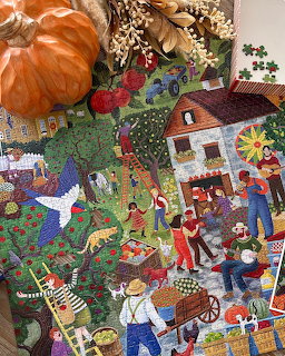 Colorful folk art illustration of people harvesting aples at a farm with a house, trees, and animals