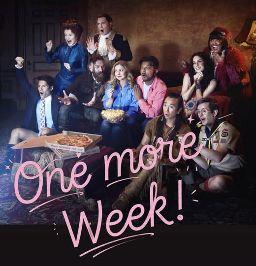 Group of people in a living room watching TV with pizza and popcorn, overlaid with pink text