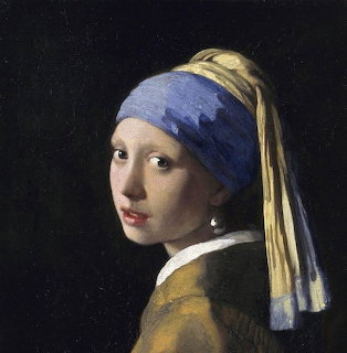 Portrait of girl in blue turban with pearl earring looking back over shoulder