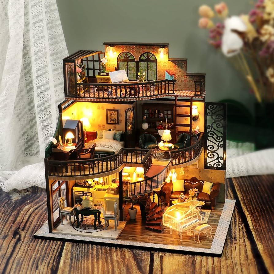 Illuminated miniature house with detailed rooms and tiny furniture on a wooden table