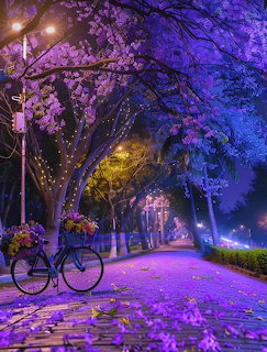 Bicycle on a cobblestone path under purple blossom trees at night