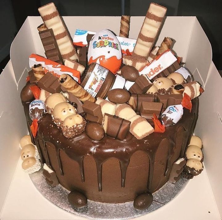 Chocolate cake decorated with Kinder candy bars and chocolate drizzle