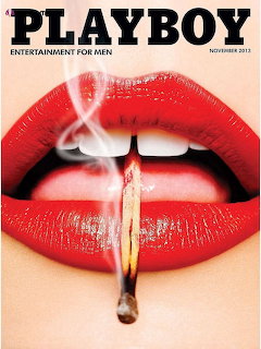 Extreme close-up of red glossy lips holding a lit cigarette with smoke rising