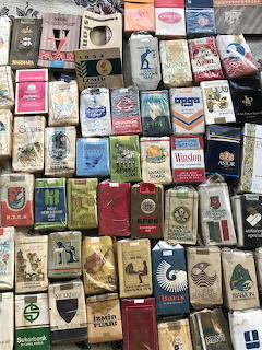 Collage of assorted vintage Italian cigarette packets arranged in rows showing various brands and colorful packaging designs