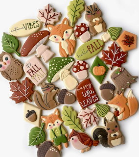Fall cookies shaped as foxes, owls, squirrels, leaves and acorns with autumn decorations