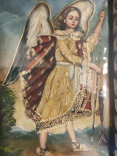 Painting of a winged child in a gold robe holding a staff beside a tree
