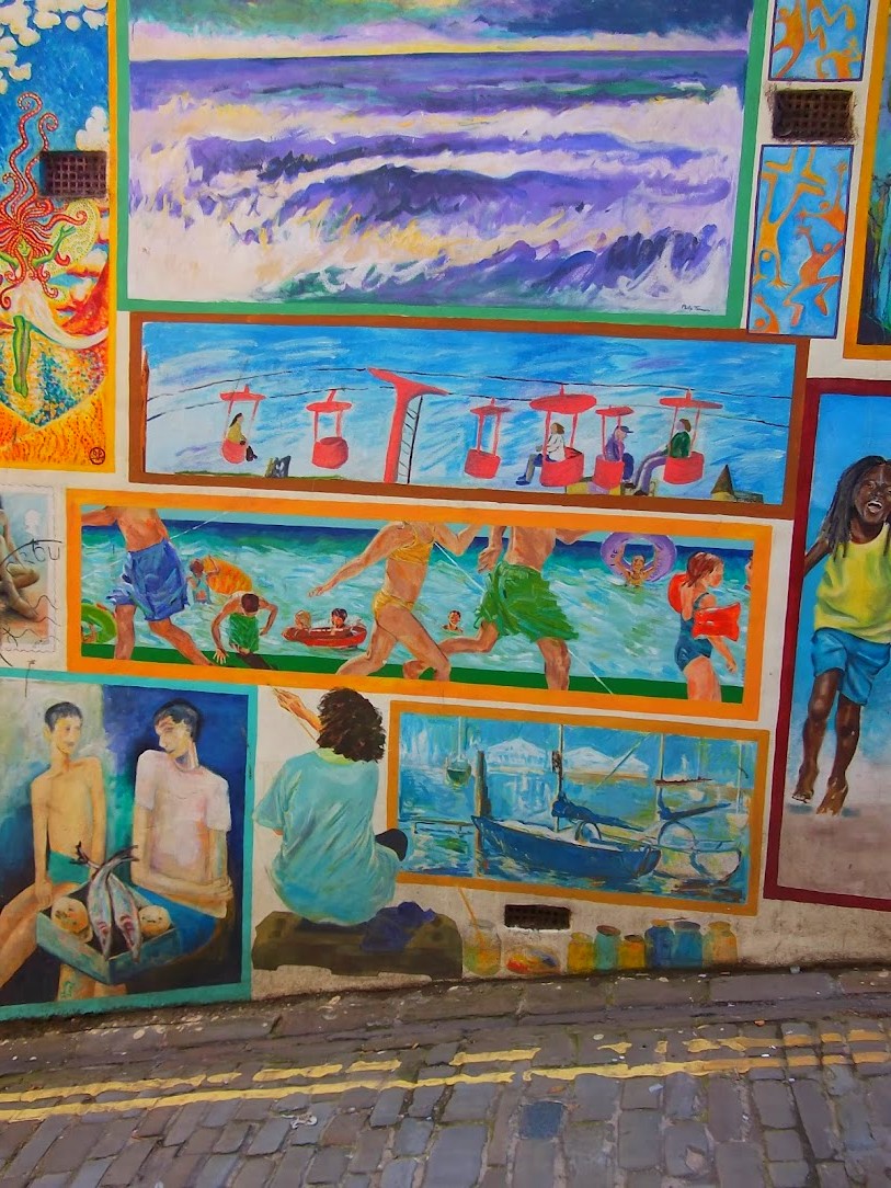 Colorful street art mural by the seaside with vibrant graffiti designs