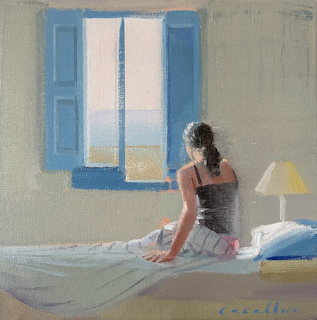 Woman sitting on bed looking at ocean through blue shuttered window in sunlit bedroom