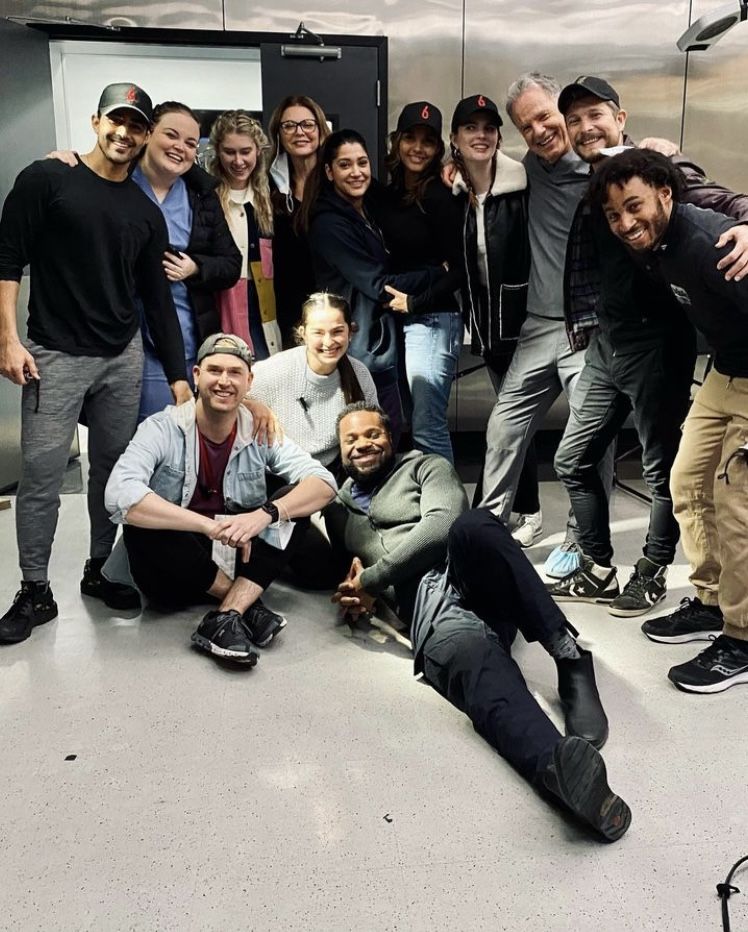 Large group of people posing together for a photo in an indoor setting