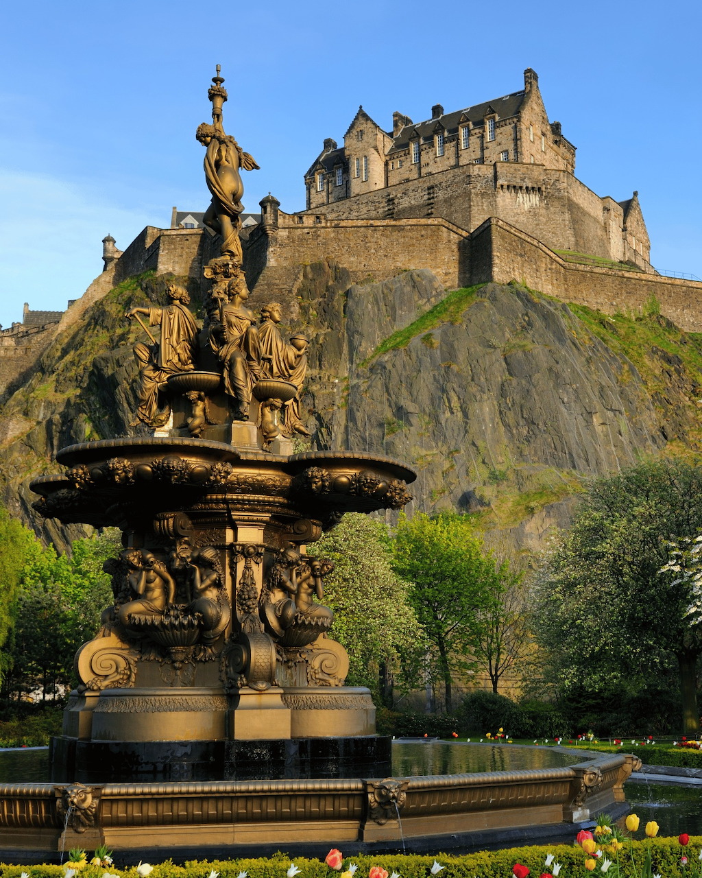 Ross Fountain in foreground with Edinburgh Castle on volcanic rock behind, spring gardens, Scotland