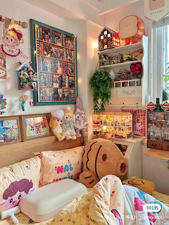 Cozy kawaii bedroom with colorful collectibles, plush toys, fairy lights, and pastel decor on shelves and walls