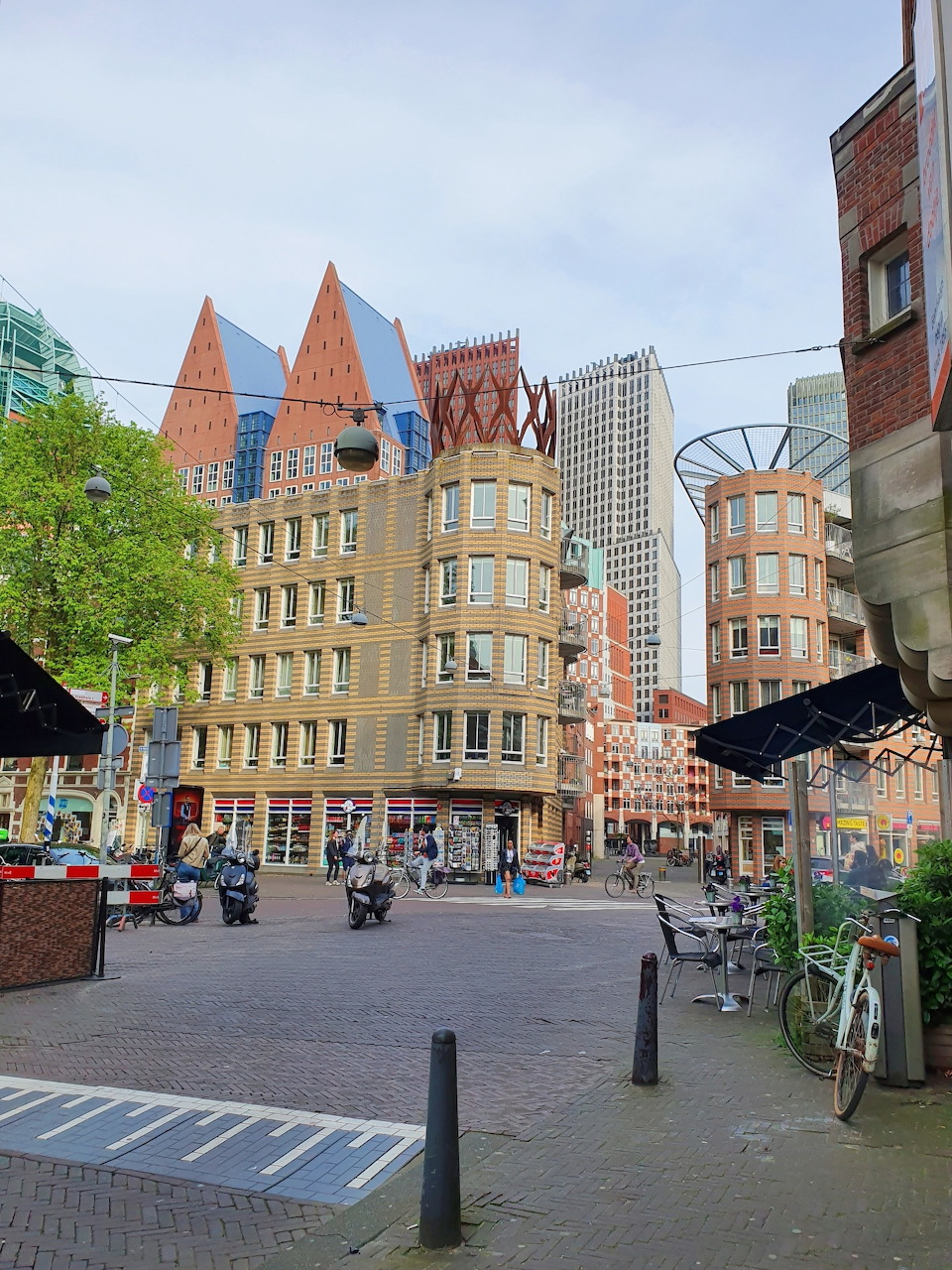 The Hague city square with mix of historic and modern architecture under overcast sky