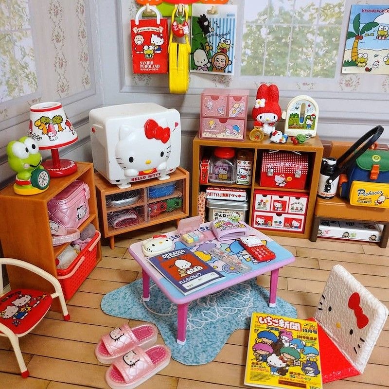 Miniature Hello Kitty themed room with toys, furniture, shelves, and colorful accessories on wooden floor