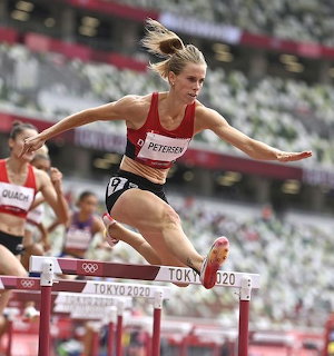 Female hurdler Petersen leaping over a hurdle at the Tokyo 2020 Olympics