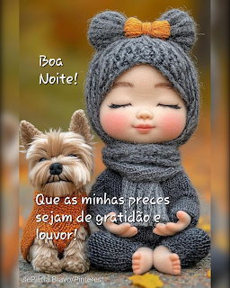 Cute knitted doll in gray bear hat sitting next to a small Yorkshire Terrier with autumn background