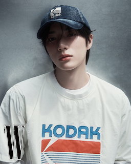 Young man in white Kodak t-shirt and blue Kodak cap, magazine photo shoot
