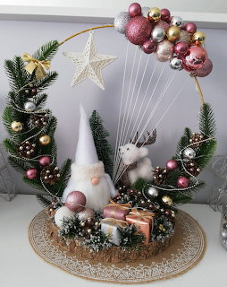 Christmas decoration with gnome, reindeer, pine branches and pink and silver baubles