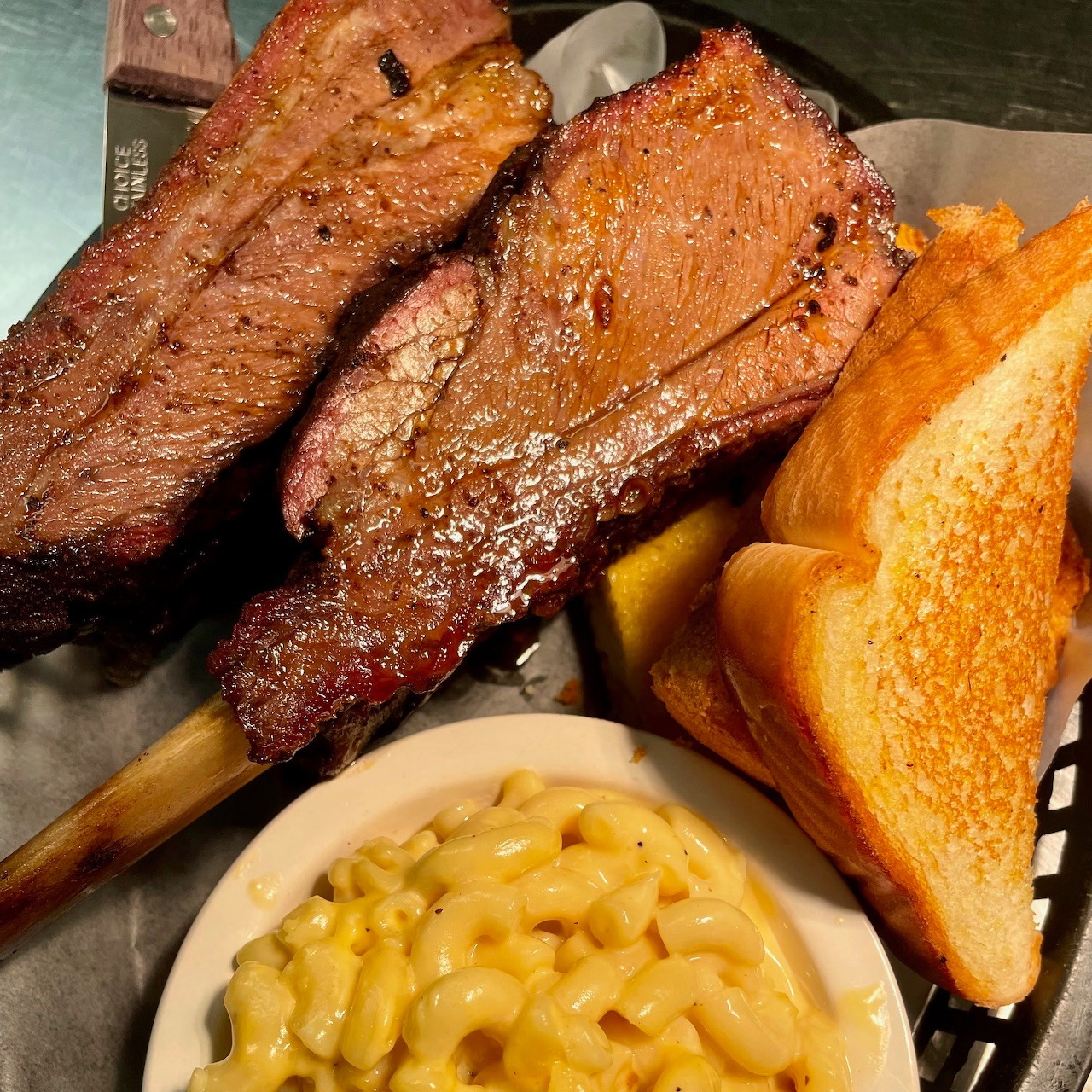 BBQ ribs with mac and cheese, cornbread, and fries on a plate