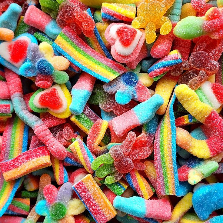 Colorful sugar-coated gummy candies in rainbow colors and assorted shapes