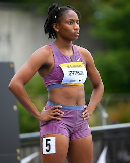 Female sprinter Jefferson in purple crop top and shorts at a Los Angeles track event, bib number 5