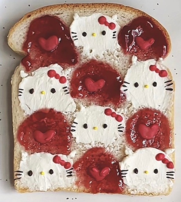 Toast decorated with eight Hello Kitty character faces arranged in rows using white rice and red jam