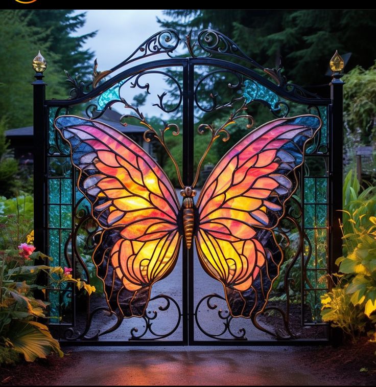Ornate garden gate featuring a large colorful butterfly design