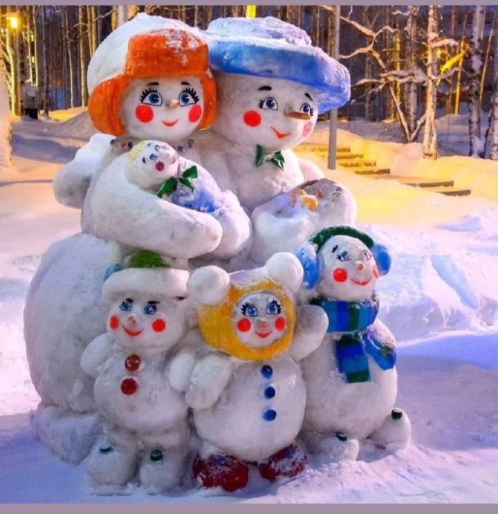 Five cute snowman figures with colorful hats standing together in snow
