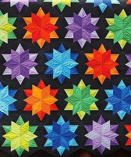 Patchwork quilt with night sky pattern, stars and moon on dark blue fabric