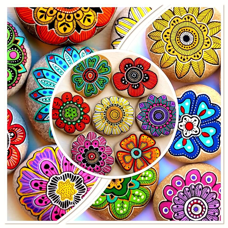 Colorful mandala-pattern decorated cookies arranged on white plate with intricate floral designs