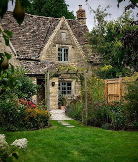 Stone cottage with garden and green lawn