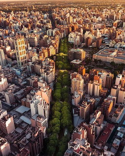 Aerial view of La Cañada tree-lined avenue through dense city buildings in Córdoba