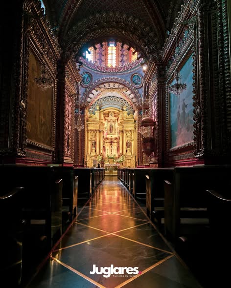 Ornate church interior with golden altar and reflective aisle