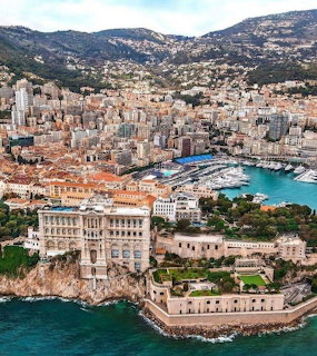 Aerial view of Monaco with the Oceanographic Museum, harbor, city buildings, and hillside