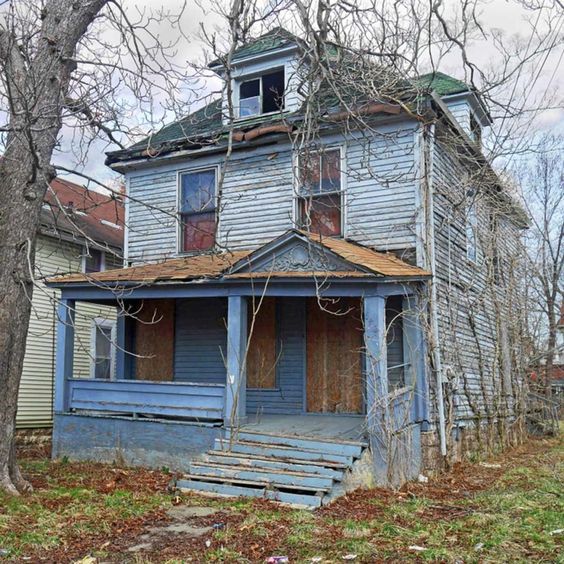 Boarded Blue House