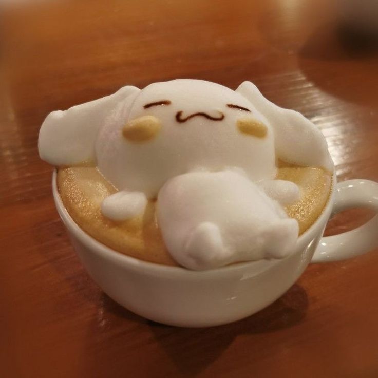 3D Cinnamoroll latte art in a white coffee cup on a wooden table