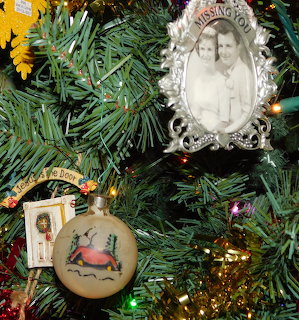 Christmas tree ornaments including a Missing You photo frame and a painted deer ball ornament