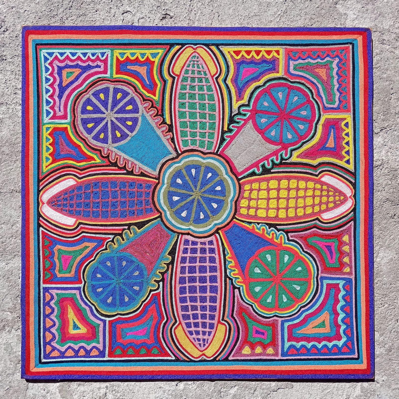 Vibrant Mexican folk art with symmetrical flower pattern in bright colors and geometric designs